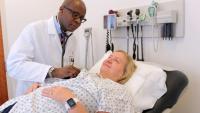 A cardiologist examines a patient